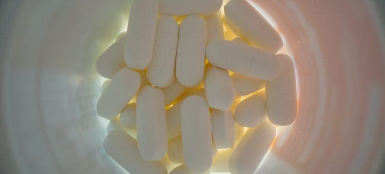 white pills in a med box